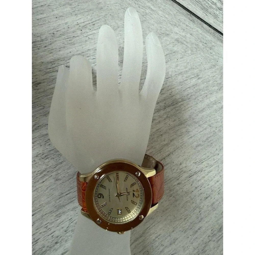 Anne Klein 10/9054 Women Gold Tone Quartz Watch Crystal Brown Enamel Bezel